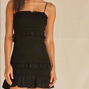 NWT. Forever 21 black smocked body-con dress with ruffles. Size L.